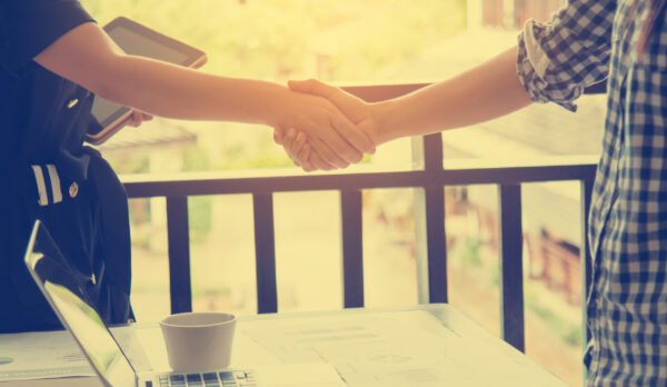 Business woman shake hands to success. Selective focus and soft flare filter.